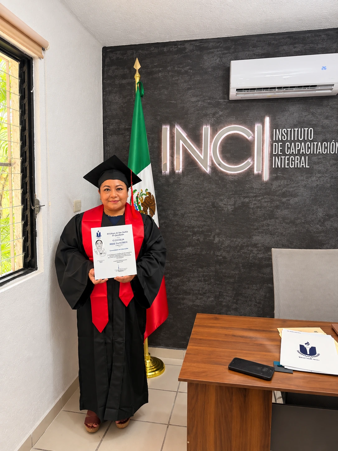 Persona graduada en INCI mostrando su constancia